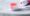 pink and white toothbrush with red toothpaste on it