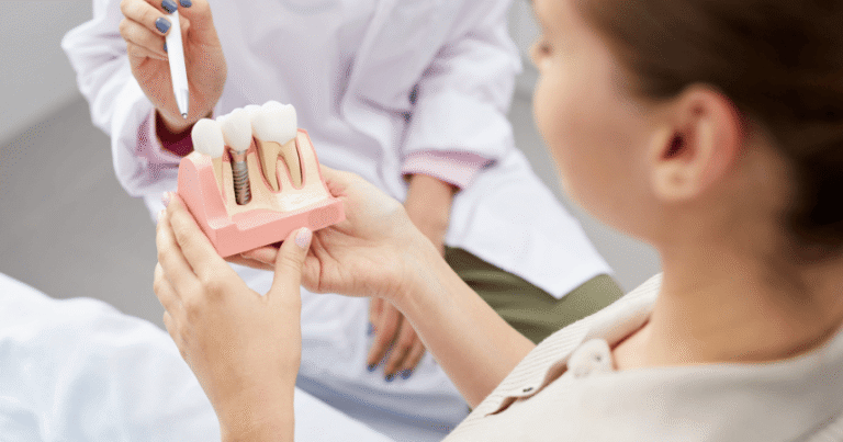 Illustrative photograph of an implant consultation using a dental model.