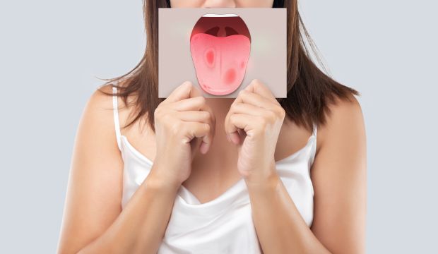 Person covering their mouth, illustrating the impact of poor oral hygiene on dental health and overall well-being.