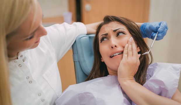Patient relaxing in dental chair, representing a calm and comfortable dental experience, addressing dental anxiety and promoting stress-free visits.