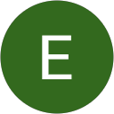 Dental Krafts logo featuring a green circular design with a prominent white letter "E," symbolizing the dental practice's commitment to care and professionalism.